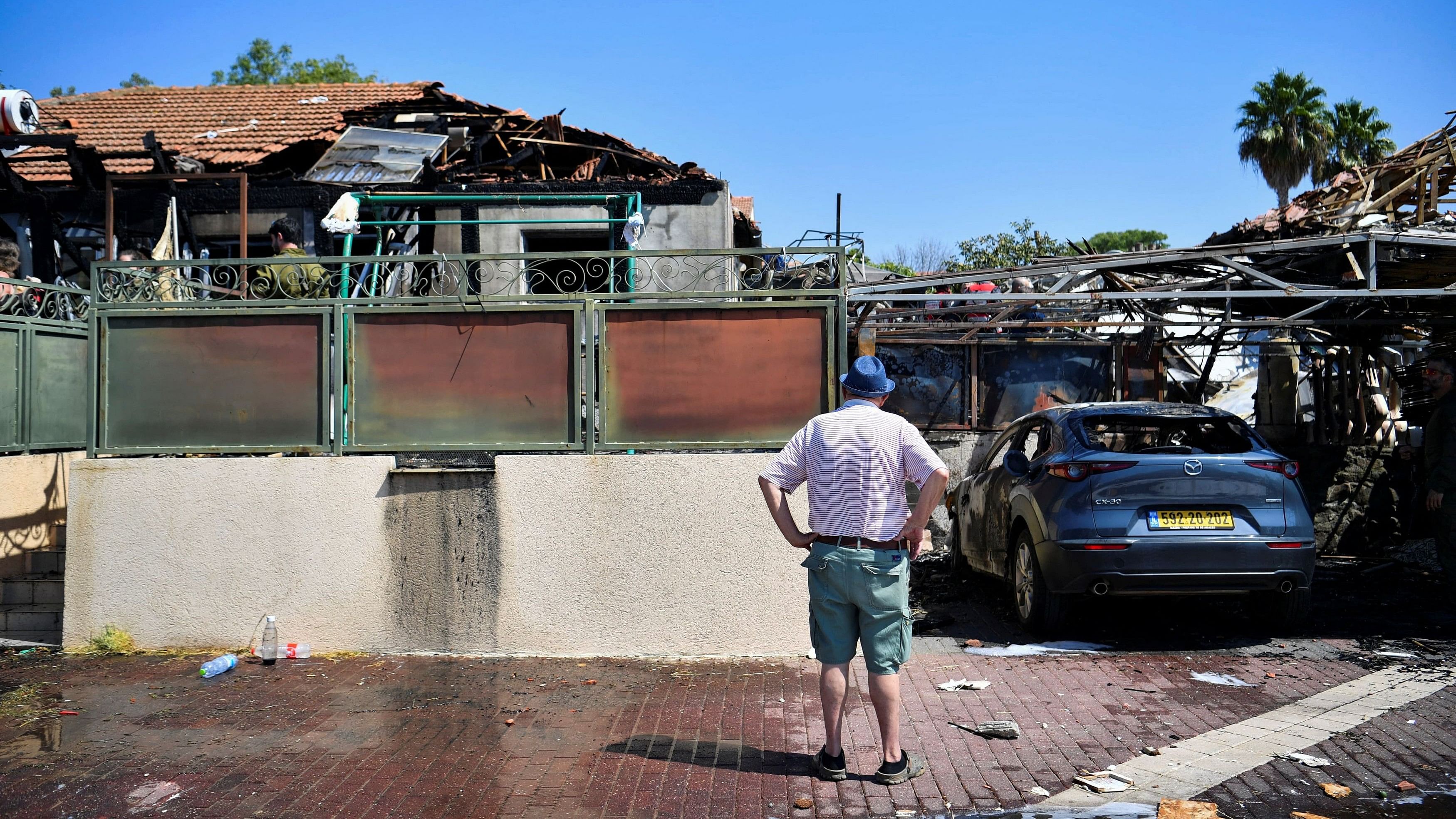 <div class="paragraphs"><p>A man looks at the damage to a house caused by rockets that were fired from Lebanon, in Katzrin in the Israeli-occupied Golan Heights</p></div>